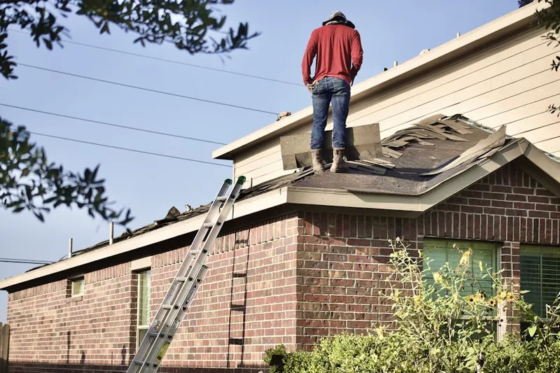 Professional roofer working on a residential roof in Stillmans Corner